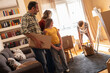 © BalanceFormCreative - A family is moving into a new apartment, unpacking boxes together in the living room. They organize their belongings and start setting up their new home.
