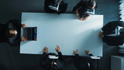 Poster - Top down aerial view of diverse data analysts wearing VR headset and stand around table while using hand gestures to manipulate the data streamed live from executive manager's laptop. Directorate.