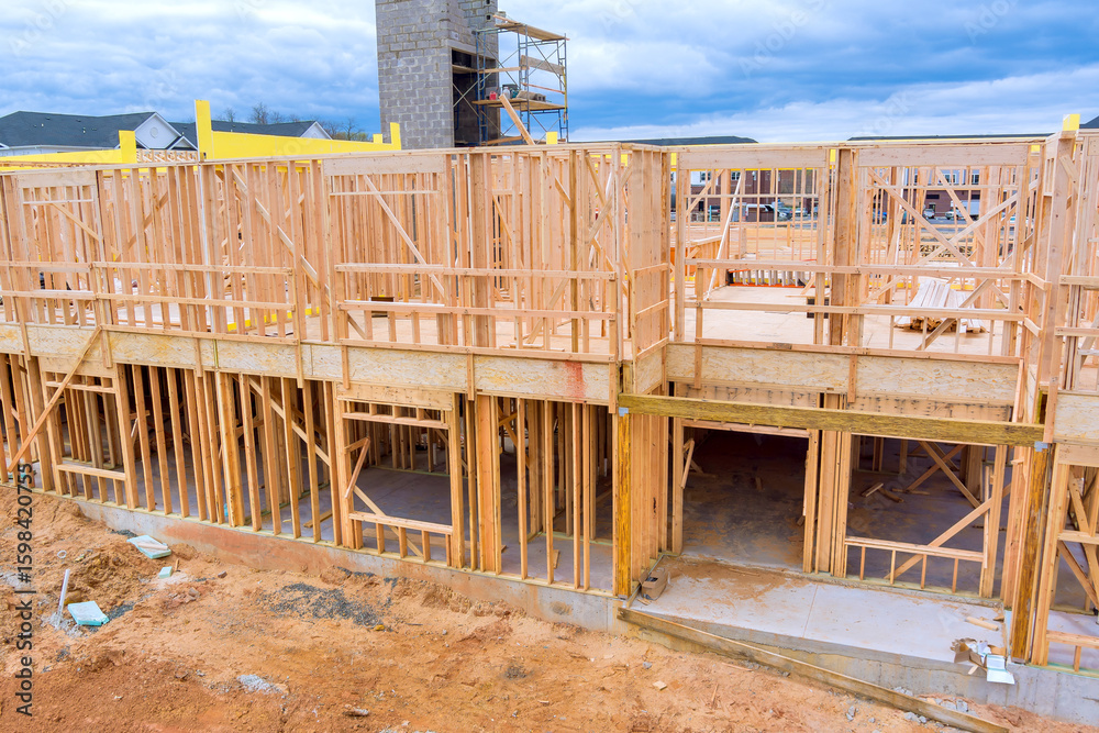 Wooden beams frames rise on construction site in residential area under ...