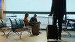 © Videophilia - Tourists waiting at the airport while businessman is walking away