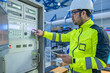 © reewungjunerr - Electrical engineer woman checking voltage at the Power Distribution Cabinet in the control room,preventive maintenance Yearly,Thailand Electrician working at company