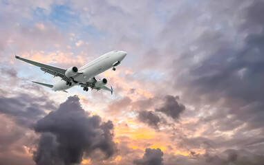 Wall Mural - airplane flying in beautiful sky with clouds at sunset