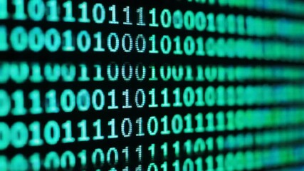 rows of binary code glowing on a dark screen