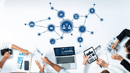 Poster - This image depicts a collaborative business meeting where professionals utilize digital tools for data visualization, enhancing strategic planning and productivity in a modern office. Amity