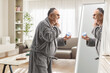 © Ljupco Smokovski - Mature man in a bathrobe using face cream