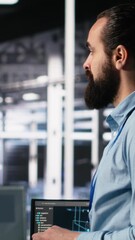 Poster - Vertical video Close up of developer in data center coding with generative AI assistance on laptop. IT expert leveraging artificial intelligence large language model on notebook to solve tasks, camera
