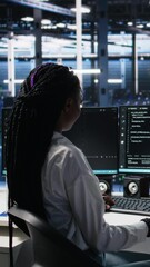 Poster - Vertical video Data center system administrator working on neural network software development. African american woman in server room implementing machine learning technology using PC, camera A