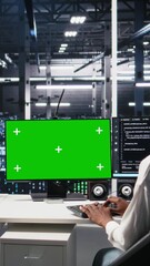 Fototapete - Vertical video Female technician and coworker in data center review AI diagnostics on isolated screen PC. IT expert and colleague optimize artificial intelligence systems using chroma key computer