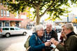 © Davor - Senior friends exploring a town together on vacation