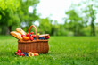 © Saichol - wicker picnic basket on green grass. Summer sunny day and picnic basket.