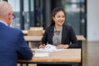 © David - Businesswoman financial expert analyzes business report graph and chart at the office. Concept of financial economy and marketing research.