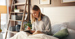 © Einero25/peopleimages.com - Happy woman, relax and writer with book in bed for morning inspiration, idea or journal in home. Female person, journalist or copywriter taking notes in bedroom for story, novel or reminder in house