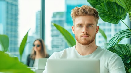 Poster - Employment Freelancer working on a laptop in a co working space with city views.