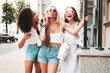 © halayalex - Three young beautiful smiling female in trendy summer clothes.Sexy carefree multiracial women posing on the street background.Positive models having fun in sunglasses. Cheerful and happy