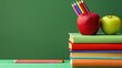 © home - Colorful books, apple, and pencil holder on a stylish desk with a green background. Ample space for promotional text concept back to school.