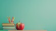 © home - Colorful books, apple, and pencil holder on a stylish desk with a green background. Ample space for promotional text concept back to school.
