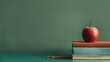 © home - Colorful books, apple, and pencil holder on a stylish desk with a green background. Ample space for promotional text concept back to school.