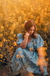 © Cavan Images - Elegant girl in retro dress. Rapeseed meadow, vintage outfit