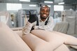 © Serhii - African american Furniture maker showing thumbs up in sofa factory