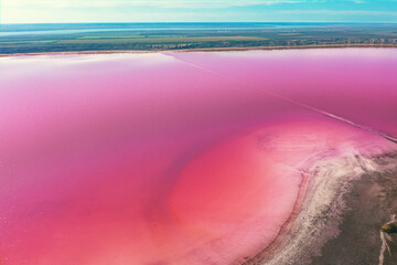 Wall Mural - Panoramic view from above on Pink Lake Kuyalnik, Odessa region, Ukraine. Salty texture of Pink Lake. Water and nature background