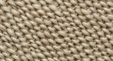 Close-up of natural woven texture with visible fibers and intricate braiding pattern in neutral tones