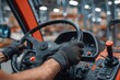 © Nik - a forklift drivers hands on the steering