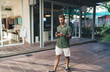 © BullRun - Man sipping smoothie while scrolling phone—demonstrates relaxed mobile consumption, app browsing ease, and fluid digital moment.