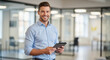 © Kaluya Stock - Portrait of a cheerful corporate leader standing in a bright office and holding tablet, showcasing professionalism and approachability.
