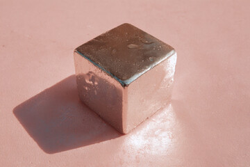 Aufkleber - Minimal flat lay of metal cube with condensation on pastel pink background, modern geometric object, cold and refreshing mood, metallic texture, clean and simple composition