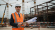 © Mostafizar - Professional Male Engineer with Tablet and Blueprints at Construction Site