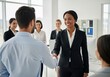 © Yhs City - Diverse Business People Shaking Hands in Modern Office Setting