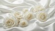 © Vadym - Delicate white roses arranged on luxurious satin fabric. Soft petals and flowing material create elegant texture. Perfect for wedding decor, romantic settings, and sophisticated crafts.