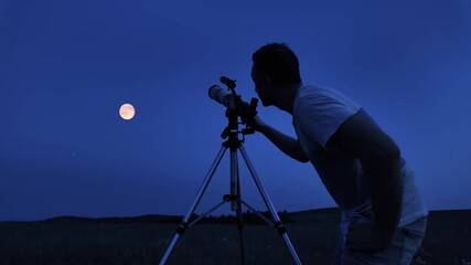 Wall Mural - amateur astronomer using telescope for watching stars, moon, planets and other celestial objects fro