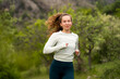 © Соня Монштейн - Portrait of young smiling woman running jogging in mountains in daylight, doing sports exercises in nature, wearing activewear leggings and long sleeve, outdoor activities in summertime