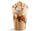 Refreshing caramel frappuccino in clear plastic cup topped with whipped cream, caramel drizzle. Cold coffee drink blends creamy ice cream, milk, sweet caramel sauce for delicious treat. Perfect for