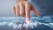 © Mrammon - A hand is pointing at a graph on a screen