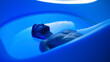 © Giacomo - A man with a beard relaxes in a capsule of sensory deprivation with a blue backlight. He lies in the water with his eyes closed, enjoying the peace and solitude.