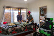© Austockphoto - Middle aged parents help each other taking care of their son with disability.