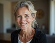 © Pixel Diversity - Headshot portrait of beautiful mid aged woman posing indoors with healthy toothy smile Happy elderly female renter tenant buyer of new apartment flat office space looking at camera at relocation day