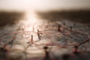 Poster - Threads intertwining on a textured surface during golden hour light