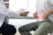 © Wasan - Man with abdominal pain, bloating, diarrhea goes to the doctor at medical clinic. Female doctor is diagnosing a patient abdominal pain in the examination room at the hospital.