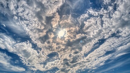 Wall Mural - Radiant sky featuring soft white clouds, ideal for desktop backgrounds