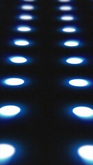 Poster - Blue illuminated circles in a grid pattern glowing over a dark surface, creating a futuristic LED look