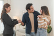 © surachetkhamsuk - Estate agent hands house keys to the client. Asian woman realtor gives keys to the couple buyer while standing in mockup house, Real estate
