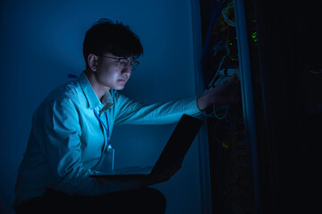 computer engineer is setting up network in server room,systems maintenance technician,male engineer 