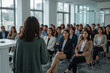 © Masud - Woman presenting to an engaged audience in a modern conference room