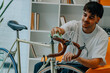 © carballo - young man cleaning or preparing vintage bicycle