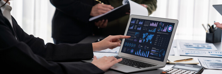 Poster - Panorama shot analyst team utilizing BI Fintech to analyze financial report with laptop. Businesspeople analyzing BI data dashboard displayed on laptop screen for business insight. Prodigy