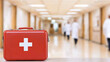 © A2Z AI  - First Aid Kit: Red medical kit on table in a hospital hallway.  Healthcare preparedness and emergency medical response concept.