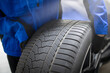 © zphoto83 - Technician inspects new tire for quality at workshop in daytime